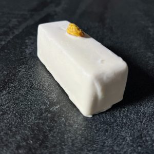 Glazed cheese bar with pistachios and raspberries