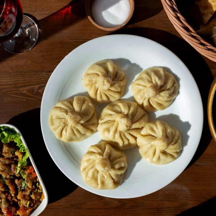 top view khinkali with meat salad bread compote and salt on the table